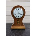 An Edwardian mahogany balloon cased mantle clock, with key, 31cm.