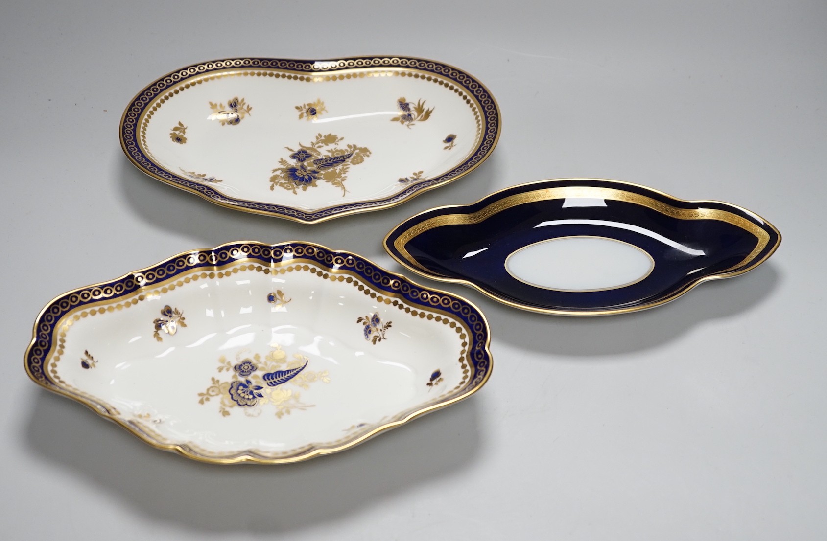 Two Royal Worcester gilt bordered dishes and a Rosenthal stand, largest 27cms wide