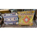 Two Turkish carpet fragment cushions, larger 72 x 50cm