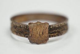 A Victorian yellow metal mourning ring, with engraved monogram and shank inset with plaited hair,