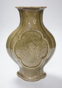 A large Chinese celadon glazed stoneware vase, incised with floral panels, 28cm