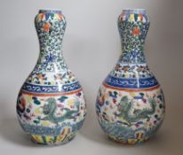 A pair of Chinese Wucai decorated vases, 34cms high