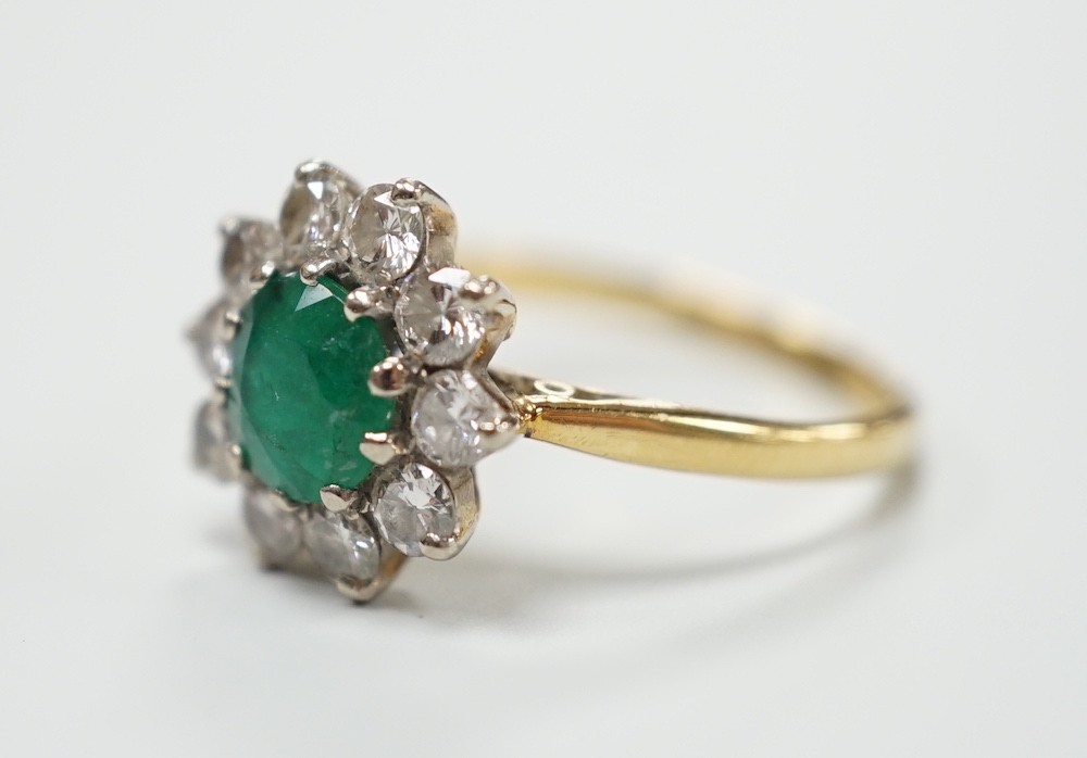 An 18ct, emerald and diamond set circular cluster ring, size K, gross weight 3 grams. - Image 2 of 4