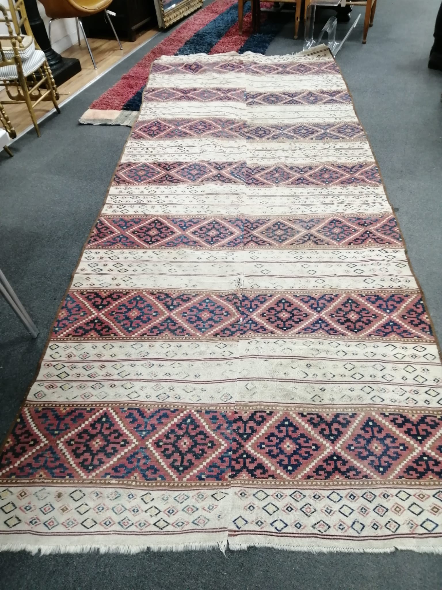 A Kelim flatweave carpet, centrally re-stitched, 385 x 150cm