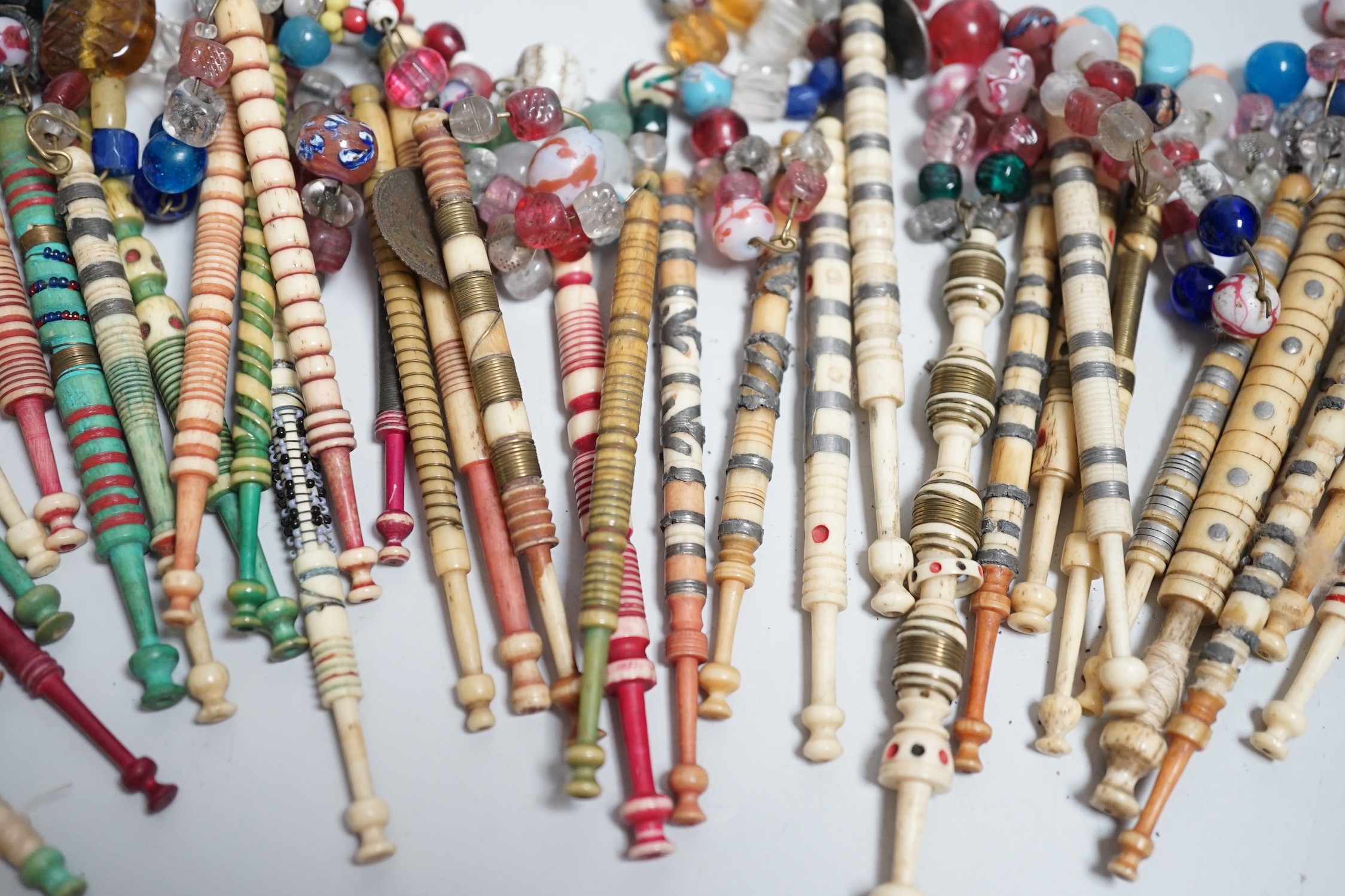 Twenty one 19th century stained and turned bone lace bobbins with glass bead tops and thirteen - Image 5 of 8