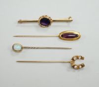 Three assorted yellow metal and gem set stick pins, including 9ct gold and diamond set horseshoe,