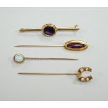 Three assorted yellow metal and gem set stick pins, including 9ct gold and diamond set horseshoe,