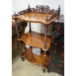 A Victorian walnut serpentine three tier whatnot, width 54cm, depth 38cm, height 104cm