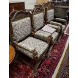 Seven (6+1) early 20th century carved oak upholstered X frame elbow chairs, largest width 75cm,