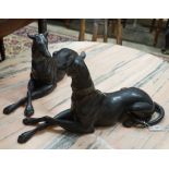 A pair of bronze recumbent greyhounds, length 67cm, height 32cm