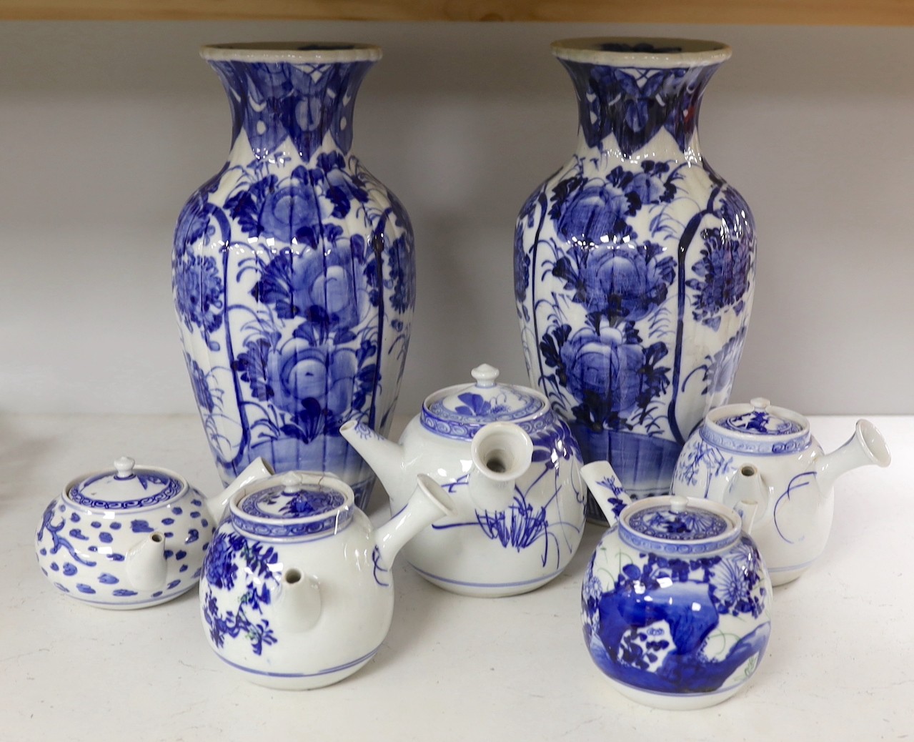 A pair of Japanese blue and white vases and various Japanese blue and white porcelain teapots and