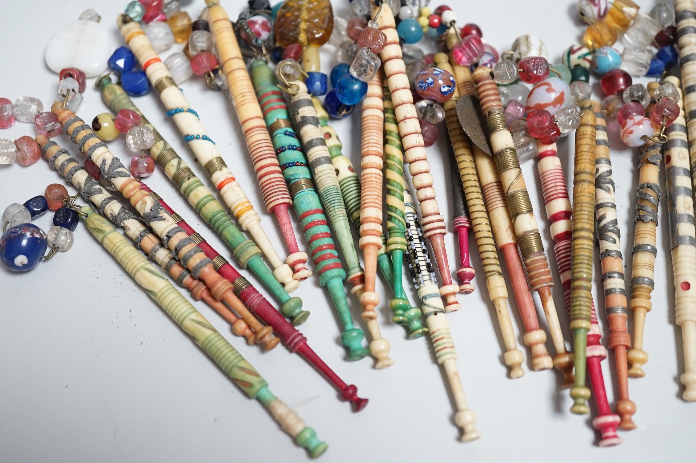 Twenty one 19th century stained and turned bone lace bobbins with glass bead tops and thirteen - Image 7 of 8