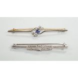 An early to mid 20th century white metal and five stone diamond set bar brooch, 50mm and a similar