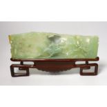 A large Chinese bowenite jade plaque of galloping horses, wood stand, 40cm wide