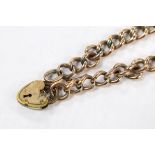 A 9ct curb link bracelet with gold plated heart shaped padlock clasp, 19.5cm, gross weight 10.8