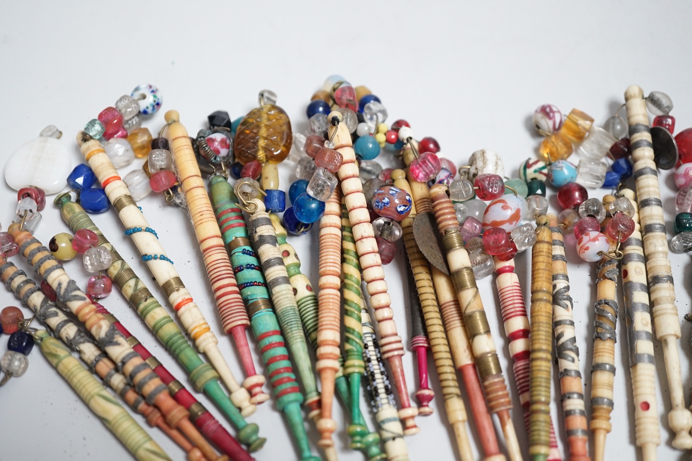 Twenty one 19th century stained and turned bone lace bobbins with glass bead tops and thirteen - Image 6 of 8