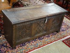 An 18th century style carved oak coffer converted from a monk's bench, width 112cm, depth 41cm,