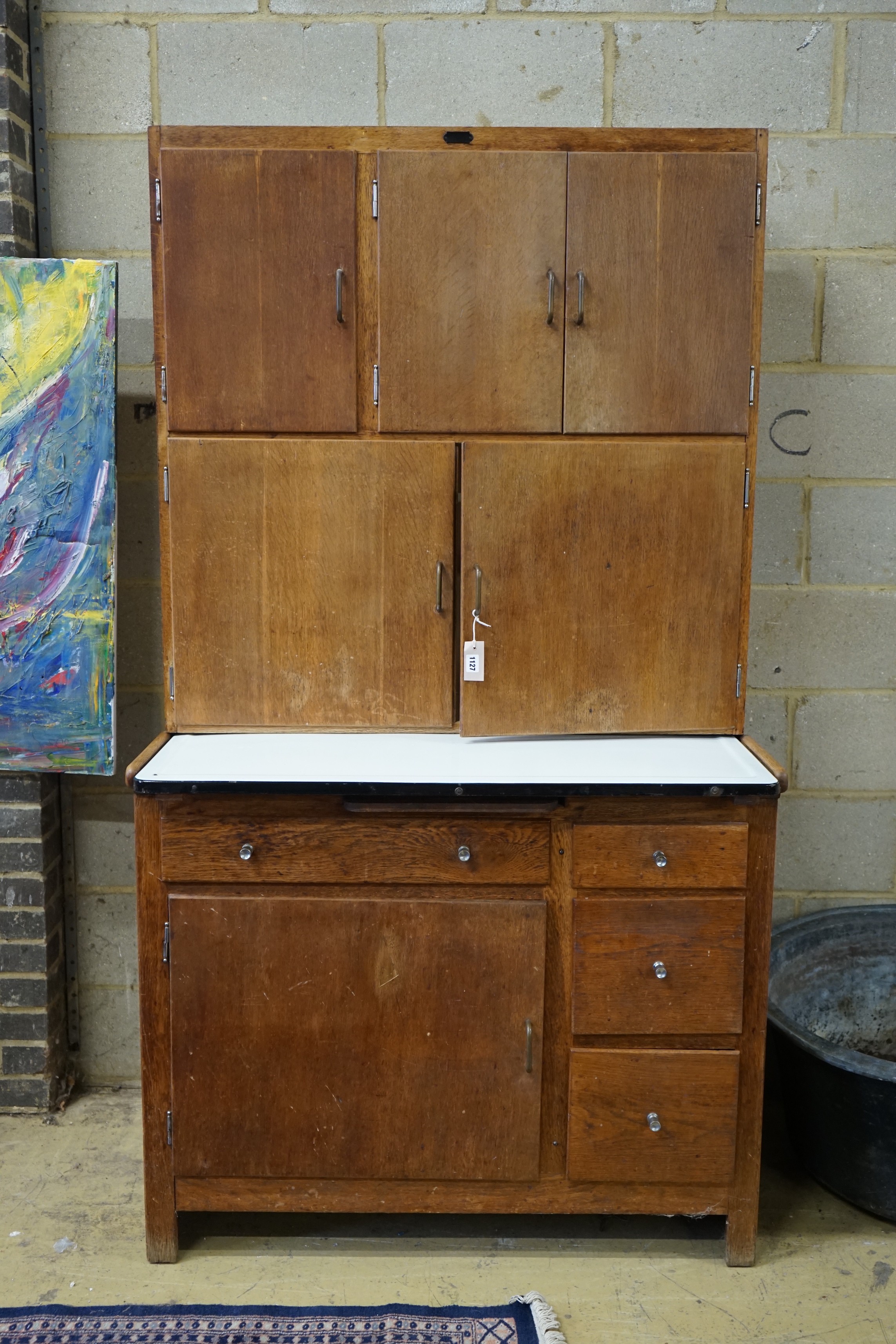An early 20th century oak 'Easiwork' enamel top kitchen cabinet Streamline Deluxe model, length