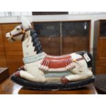 An Indonesian painted carved wood rocking horse, length 75cm, height 66cm