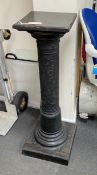 An ebonized and embossed leather covered pedestal, height 114cm.