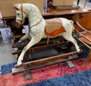 An early 20th century carved wood dapple grey rocking horse on safety frame, height 95cm