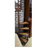 A set of reproduction Victorian style mahogany four tread library steps on brass castors, height