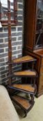 A set of reproduction Victorian style mahogany four tread library steps on brass castors, height