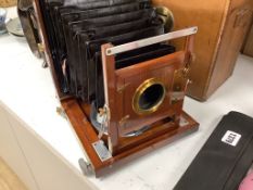 A leather cased Army & Navy auxillery mahogany and brass folding camera, Newton & Co. Lens