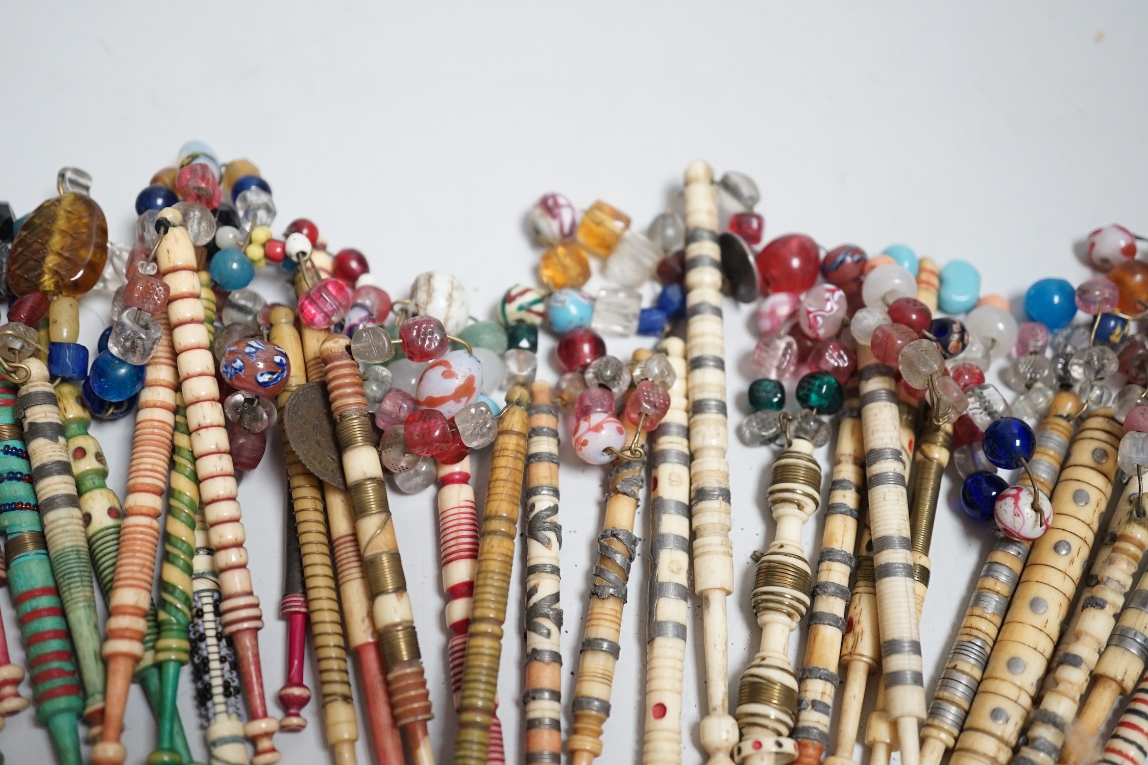 Twenty one 19th century stained and turned bone lace bobbins with glass bead tops and thirteen - Image 4 of 8