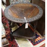 A 1920's circular oak drop flap two tier occasional table, diameter 61cm, height 69cm