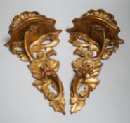 A pair of Italian gilt wood wall brackets in rococo style, early 20th century, 44cm long