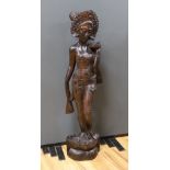 An unusually large and well-carved Balinese ebony figure of a standing young girl, early/mid 20th