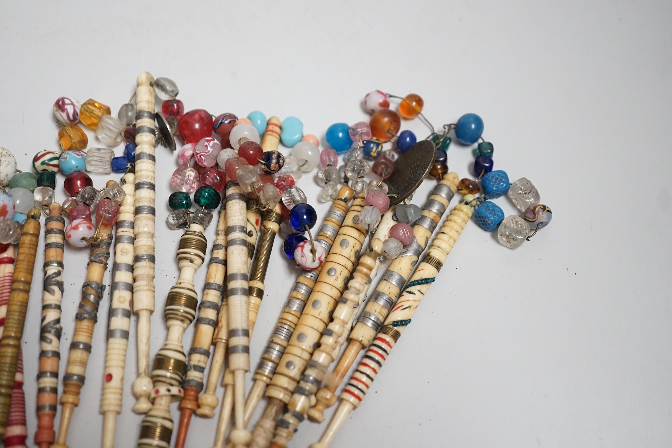 Twenty one 19th century stained and turned bone lace bobbins with glass bead tops and thirteen - Image 2 of 8