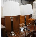 A pair of Oka gilt metal mounted and black lacquer table lamps and shades, height with shades 97cm