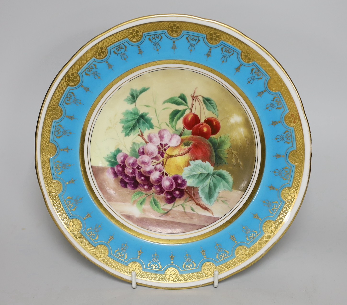 A Minton plate painted with fruit under a turquoise border, 23cm