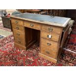 A late Victorian oak drop flap kneehole desk, length 130cm, depth 66cm, height 84cm