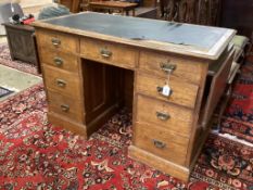 A late Victorian oak drop flap kneehole desk, length 130cm, depth 66cm, height 84cm