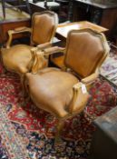 A pair of Louis XVI style carved walnut and tan leather fauteuils, width 62cm, depth 55cm, height
