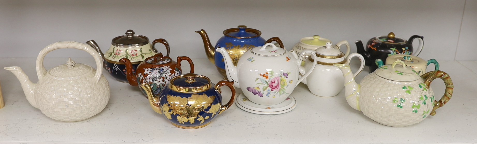 A quantity of various teapots including Belleek, Japanese Satsuma etc.