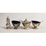 A George V silver four piece condiment set, by Adie Brothers, Birmingham, 1932 and two associated