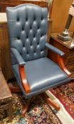 A Regency style mahogany blue buttoned leather swivel desk chair, width 58cm, depth 55cm, height