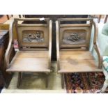 A pair of carved oak Glastonbury type chairs, width 58cm, depth 48cm, height 86cm