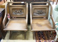 A pair of carved oak Glastonbury type chairs, width 58cm, depth 48cm, height 86cm