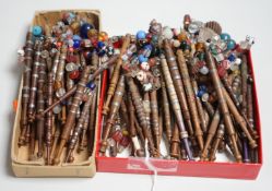Eighty 19th century wood and metal decorated lace bobbins with coloured beaded tops