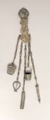 A Victorian white metal chatelaine with five accessories, import maker's mark for B.H. Joseph &