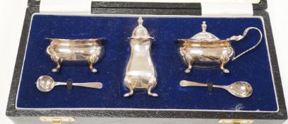 A modern silver three piece condiment set, and two spoons, boxed, Birmingham, 1975.