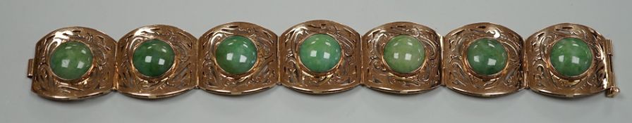 A continental 18k yellow metal and seven stone cabochon jade set bracelet, with pierced links, 18.