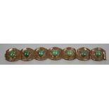 A continental 18k yellow metal and seven stone cabochon jade set bracelet, with pierced links, 18.