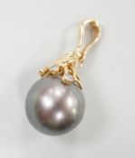 A modern 585 yellow metal, single stone Tahitian pearl and five stone diamond chip set pendant,