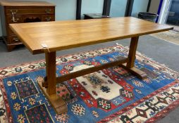 An Arts and Crafts style rectangular light oak refectory dining table, length 183cm, width 76cm,